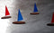 Sailboat Mobile in action-Boats with red and blue sails and beautifully varnished hulls sailing through the air