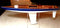 Wooden Model Sailboat: An RC Sailboat Hull Displayed on one of Our Table Stands