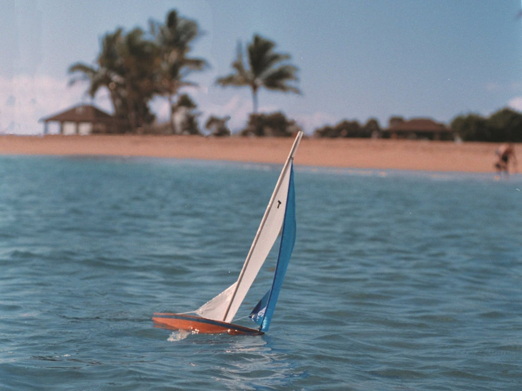 Wooden Toy Sailboat Sailing in the wind