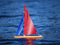 Wooden Toy Sailboat: T12 Cruiser with red and blue sails